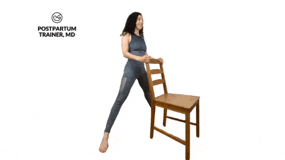 squatting while holding a chair for support