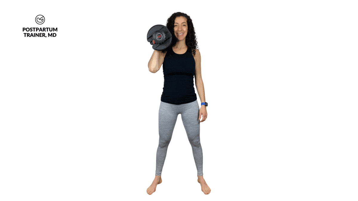 pregnant woman performing uneven squats with dumbbell in right hand