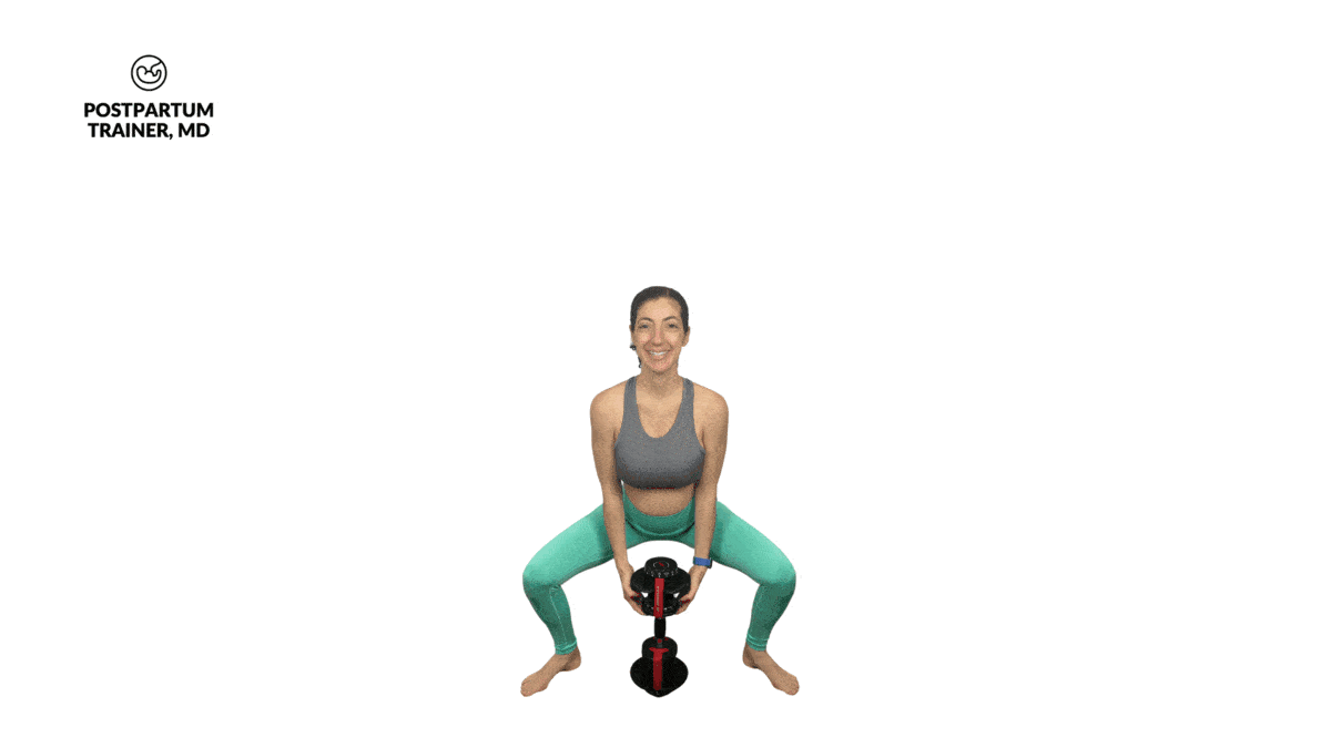 pregnant woman performing sumo squat with a dumbbell