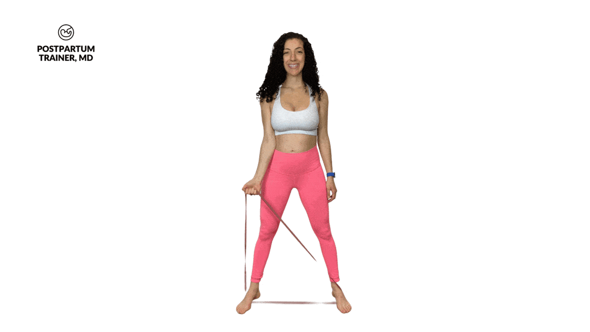 pregnant woman performing one handed resistance band bicep curls