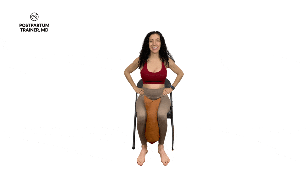 pregnant woman doing seated ball squeezes
