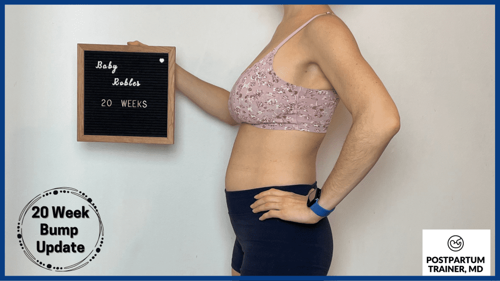 brittany holding up sign at 20 weeks pregnant from side