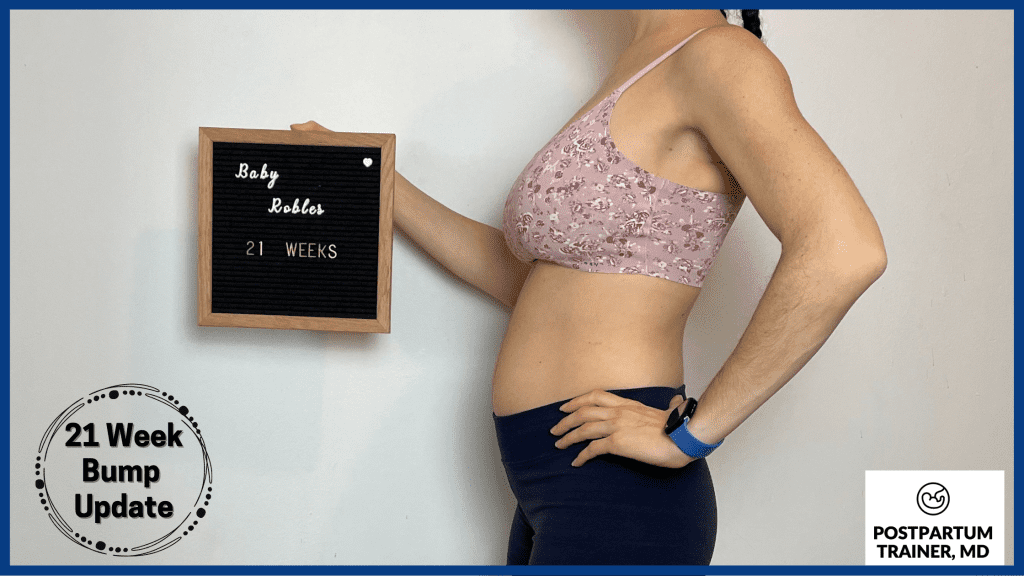 brittany holding up sign at 21 weeks pregnant from side