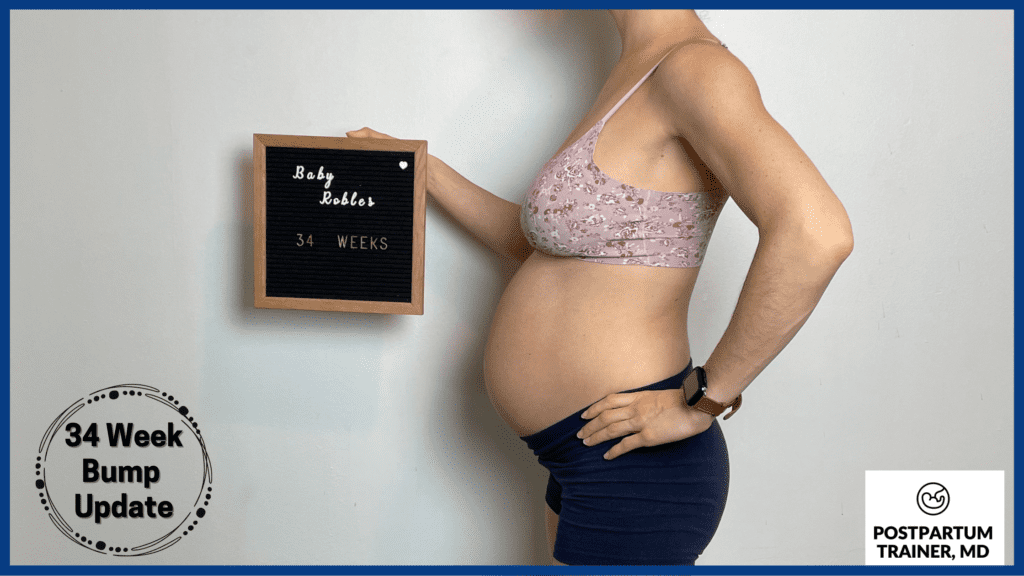 brittany holding up sign at 34 weeks pregnant from side